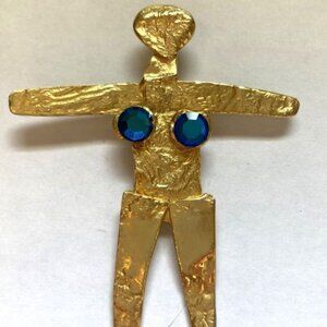 Female figure pendant with two blue stones created by Joanne Cooper in 1980s